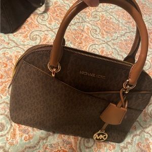 Michael Kors handbag with handles.